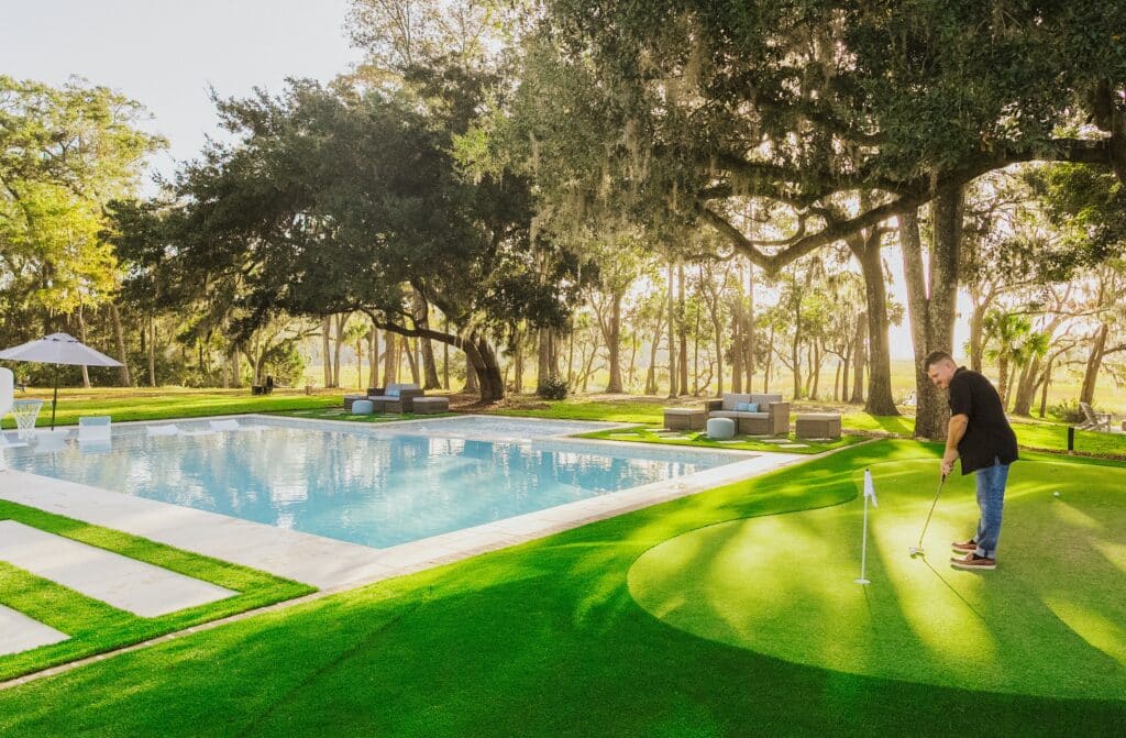 Custom gunite pool with backyard putting green under live oaks in Myrtle Beach, SC