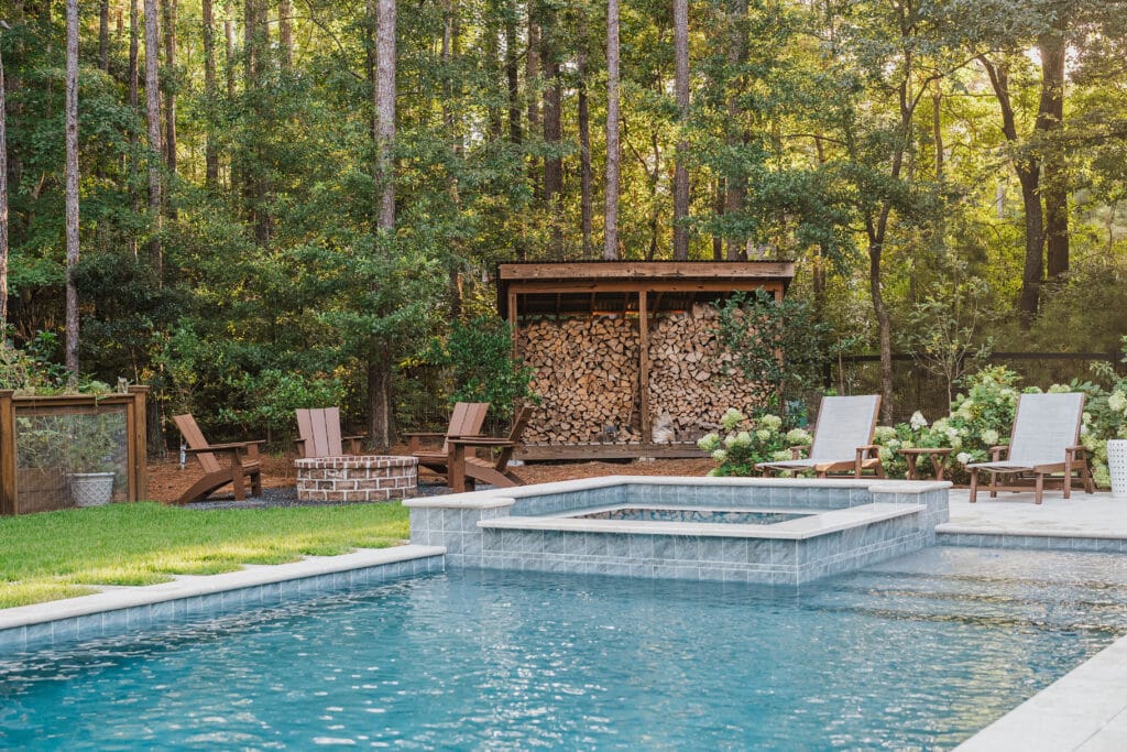 Custom gunite pool with raised spa, fire pit and wooded backyard in South Carolina